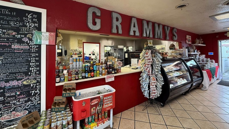 Interior view of Grammy's counter and chalkboard menu surrounded by displays of food