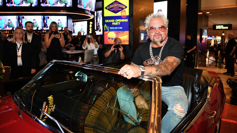 Guy Fieri sitting in his Camaro seen on "Diners, Drive-Ins and Dives" at a grand opening party