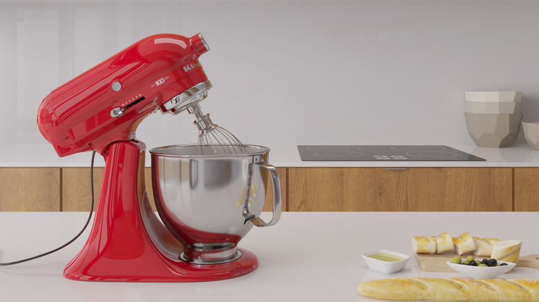 A red KitchenAid stand mixer on a kitchen counter