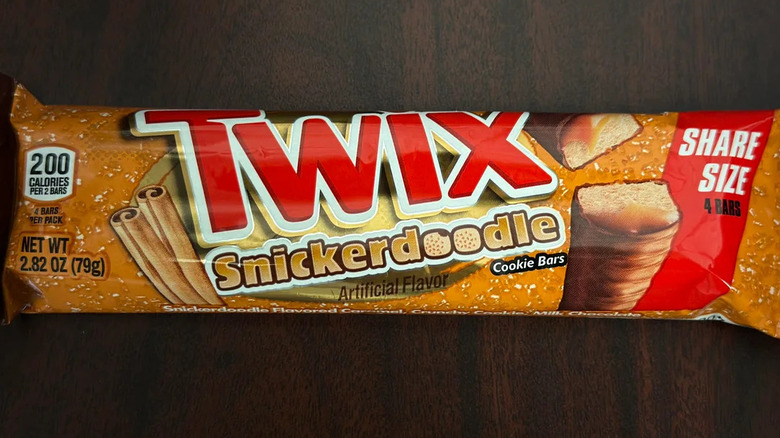 Orange package of Twix Snickerdoodle on wooden background