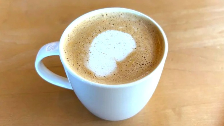 Starbucks Pecan Oatmilk Cortado in white mug on wooden table