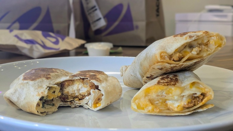 Two pieces of tortilla wraps on the right and a quesadilla with a bite missing on the right