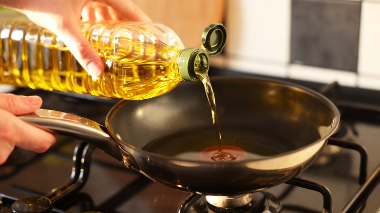Pouring vegetable oil into frying pan