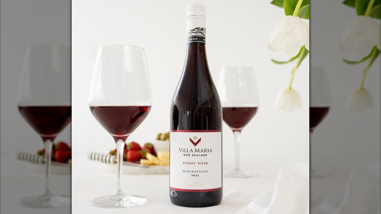 bottle of red wine with two glasses