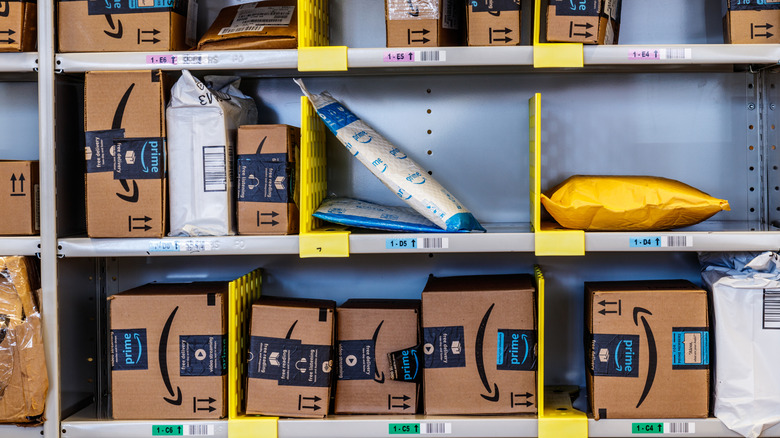 Shelves stocked with various Amazon parcels