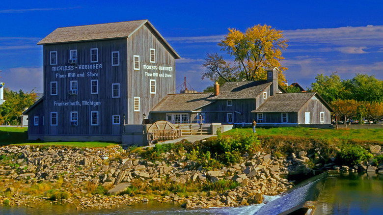 A water mill next to a running river