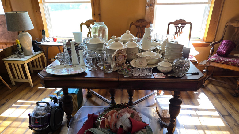 A table at an estate sale covered in various vintage items