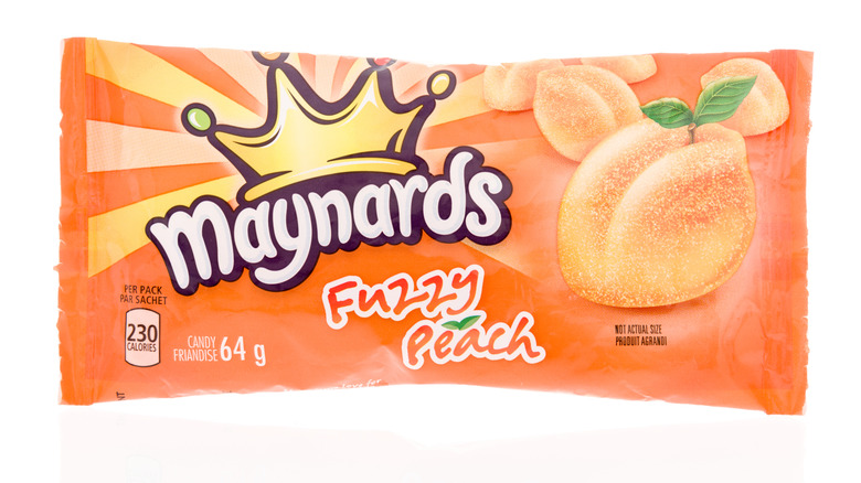 A package of Maynards fuzzy peach candy on an isolated background