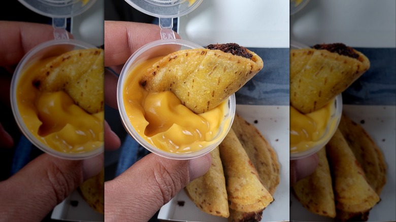 Kwik Trip mini taco dunked in nacho cheese sauce