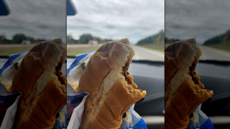 Hand holding Kwik Trip rib sandwich