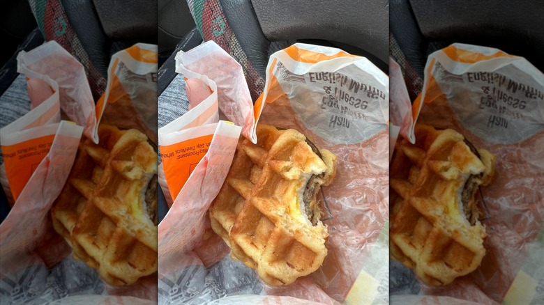 Kwik Trip waffle breakfast sandwich with bite taken out in paper wrapper