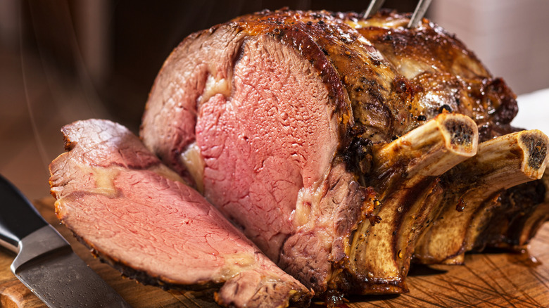 Sliced prime rib roast on a cutting board