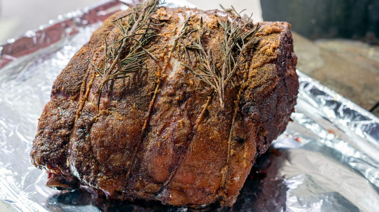 Cooked prime rib wrapped on a tray