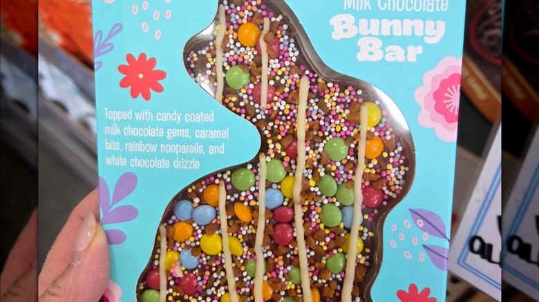 customer holding decorated chocolate bunny