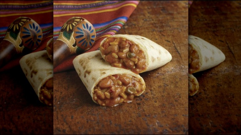 Amy's Gluten-Free Non-Dairy Bean and Rice Burrito cut in half on a table