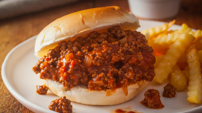 Sloppy Joe sandwich on plate with crinkle fries