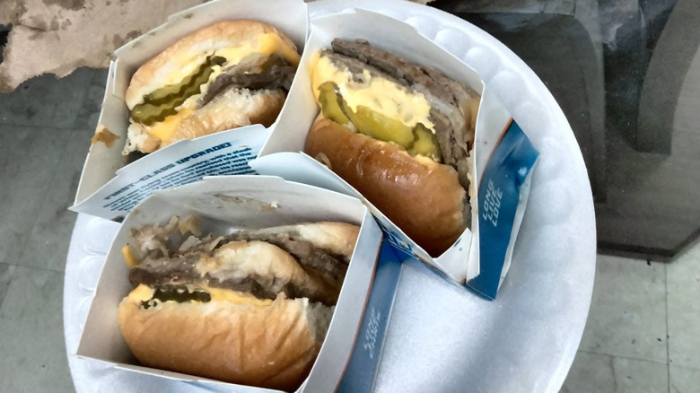 Three White Castle Jalapeño Doubles in cartons on paper plate