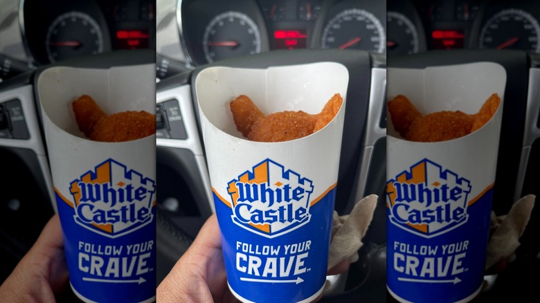 Hand holding carton of White Castle Onion Chips