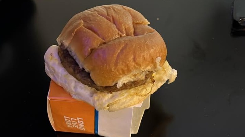 White Castle Sausage, Egg, and Cheese Slider sitting on carton