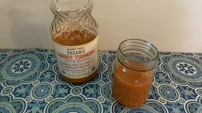 A glass of Organic Carrot Turmeric Juice Blend