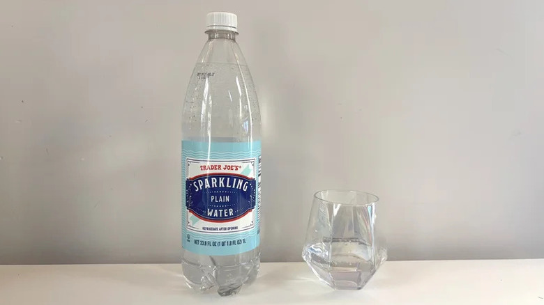 Bottle of Plain Sparkling Water next to glass