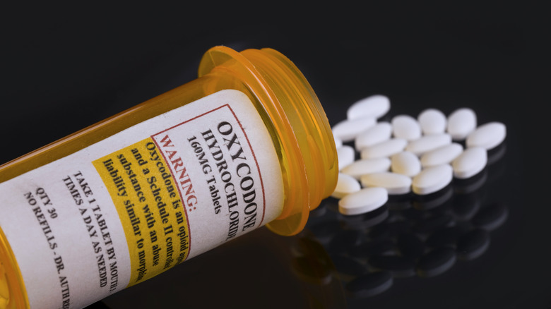 Open bottle of Oxycodone with pills spilling out