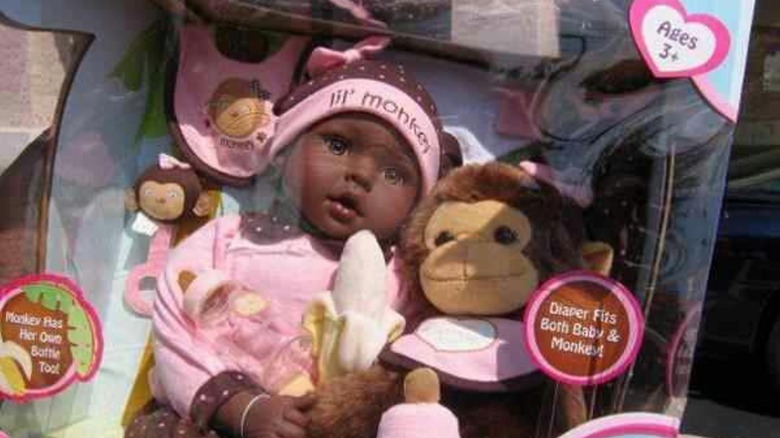 Cuddle Me Lil' Monkey black doll in package with banana and monkey