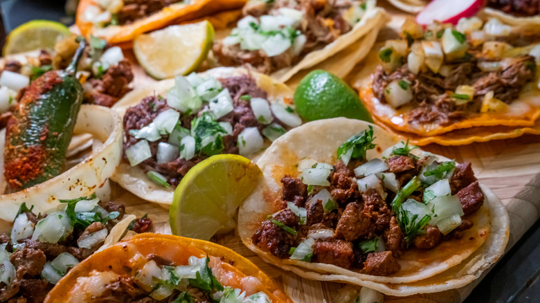 Variety of tacos with double tortillas on table