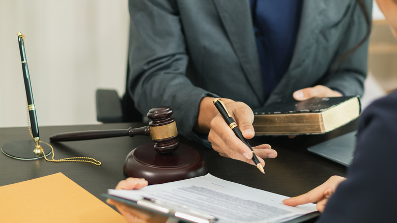 close up of client meet with a lawyer over paperwork