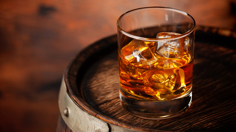 Whiskey glass on barrel