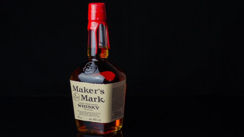 A bottle of Maker's Mark shown on a plain black background