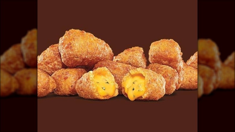 A pile of chili cheese bites on a brown background
