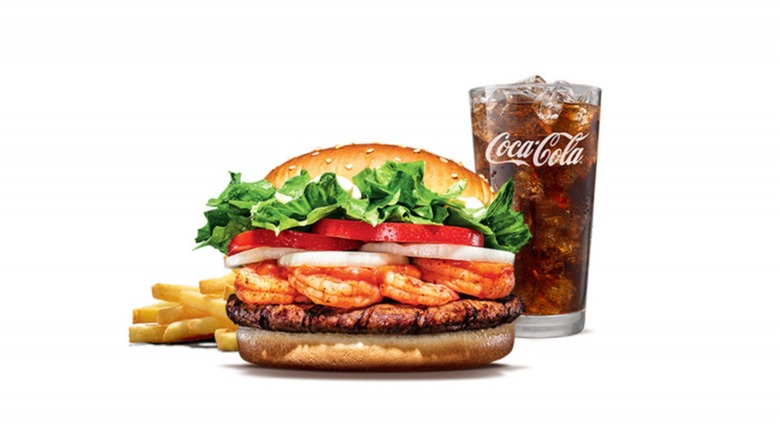 A shrimp burger, fries, and a glass of Coca-Cola