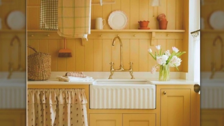 A kitchen drenched in butter-yellow with vintage fabrics