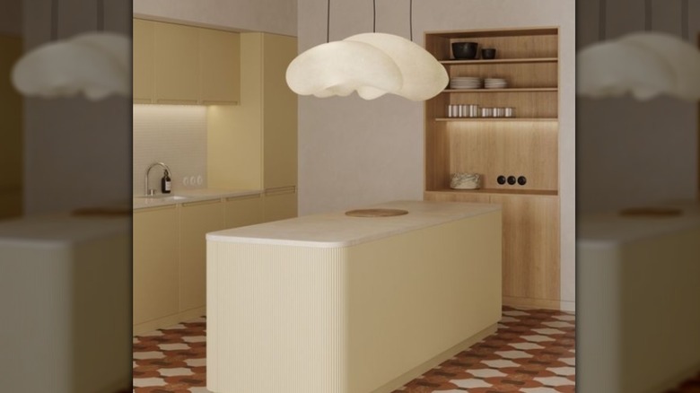 A kitchen island in butter-yellow with cloud lighting