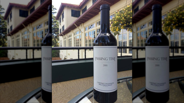 Bottle of Passing Time Walla Walla Cabernet Sauvignonred on a glass table
