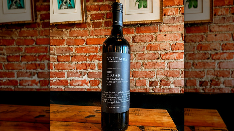 Bottle of red wine Yalumba The Cigar Cabernet Sauvignon with brick wall background