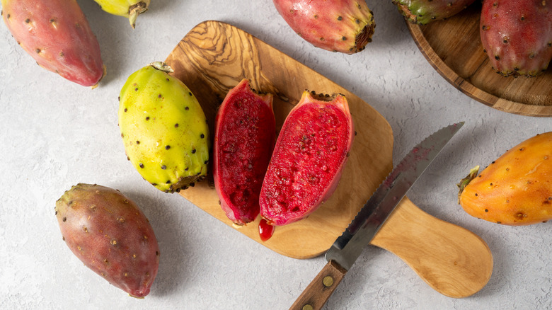 Prickly pears cactus fruit cut open on chopping board