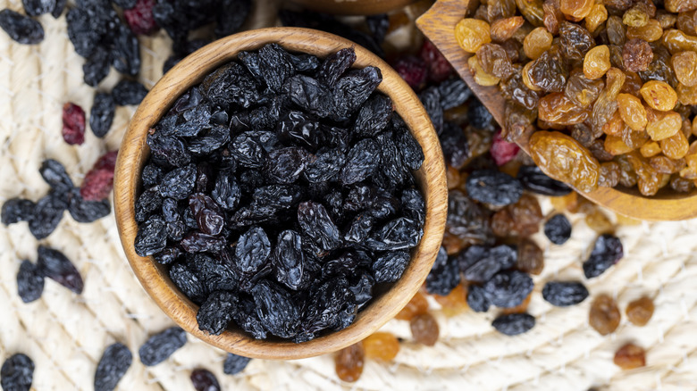 Different types of raisins in wooden bowls