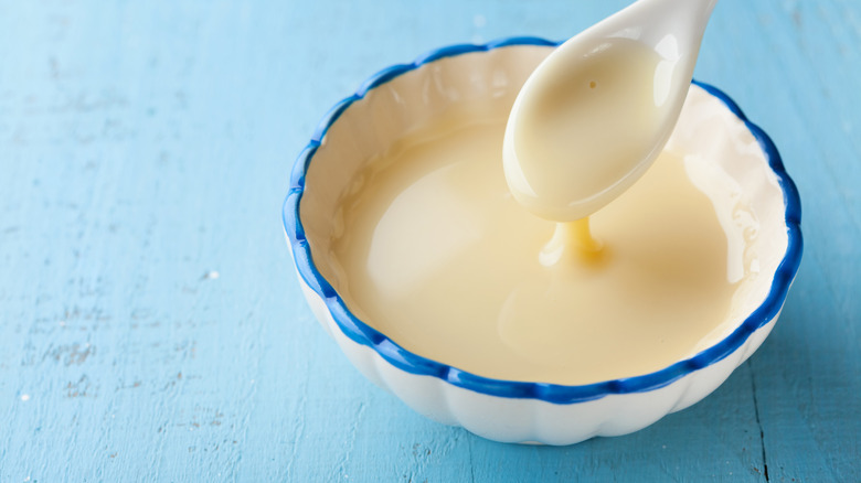 Spooning condensed milk from bowl