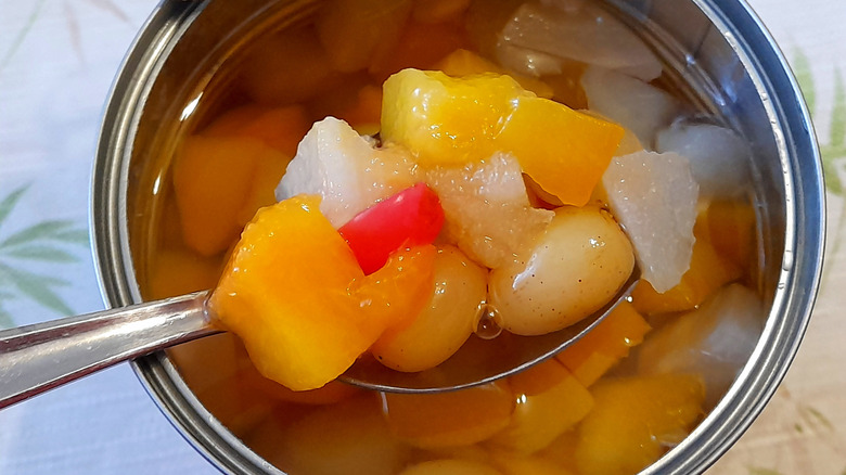 Spooning fruit cocktail out of can