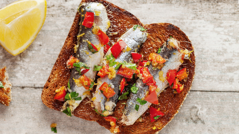 Sardines on toast with diced red pepper and herbs