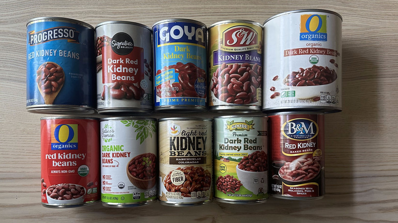 Cans of kidney beans arranged on wooden table