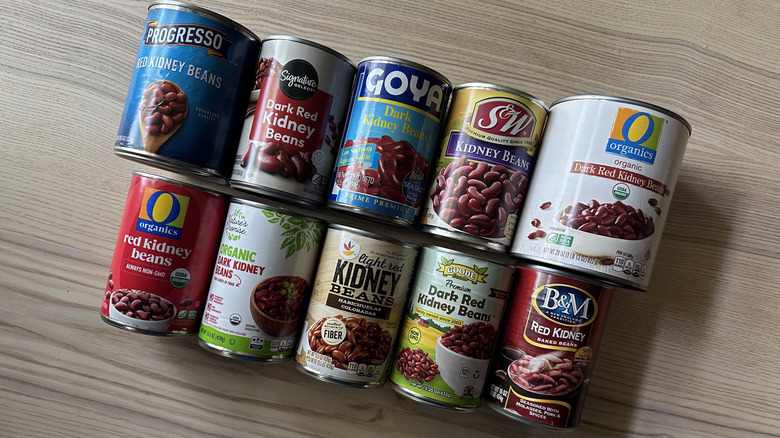 Cans of kidney beans arranged on wooden table