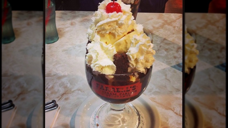 Mirrored image of giant Farrell's sundae on diner table