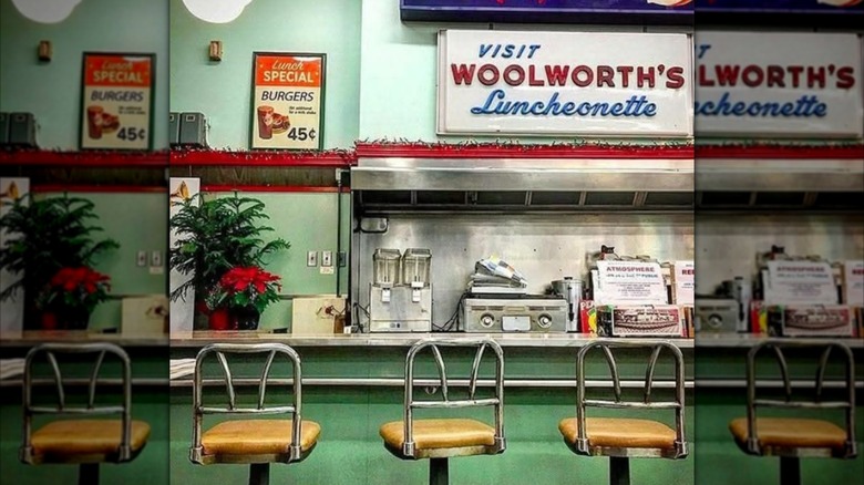 Mirrored image of three stools at green Woolworth's Lunch Counter in the 1950s