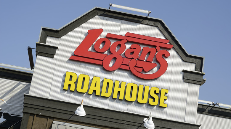 Sign on Logan's Roadhouse restaurant against blue sky
