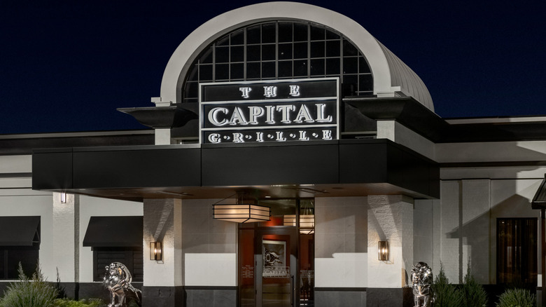 The Capital Grille restaurant sign on building at night