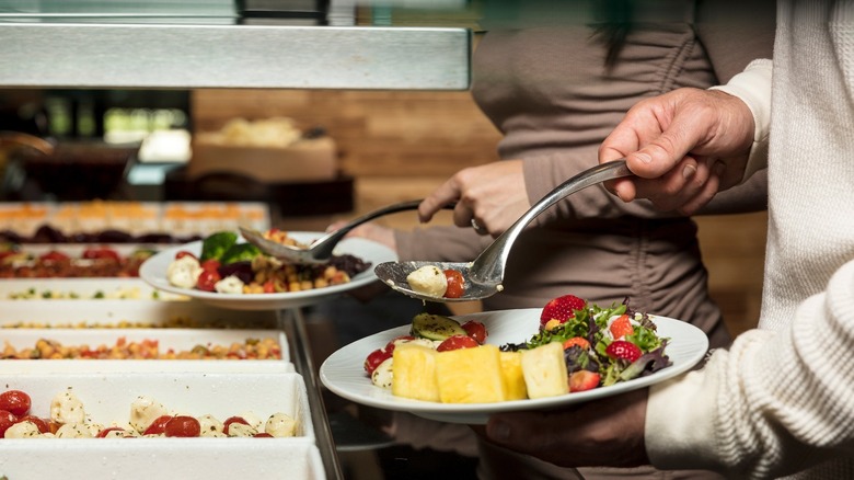 People serving themselves at Rodizio Grill's salad bar
