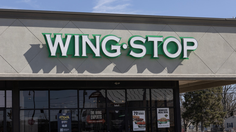 A close up of the front entrance of a Wingstop, with focus on the logo above the doors